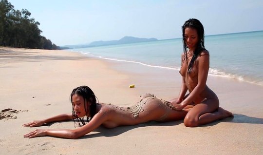 Mulatto and Asian - lesbians love sex outdoors, on the beach